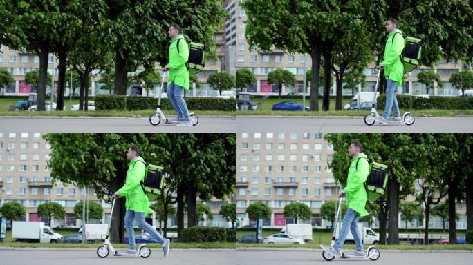 侧面跟踪绿色制服年轻食品快递员的左镜头慢动作骑着踏板车沿着城市街道行驶，携带隔热背包