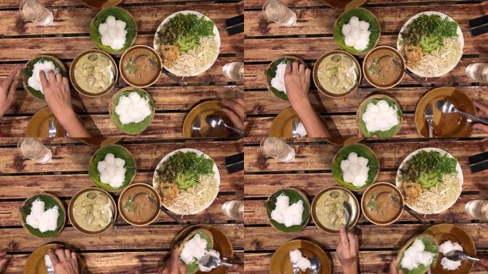 餐桌上的泰国菜: 泰国白米粉面条或米粉配绿咖喱和蔬菜的诺森食品。本地和传统方式。泰国菜背景。享受饮食