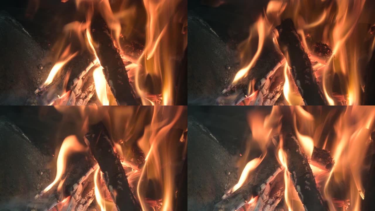 通过玻璃开窗的炉子看到木材燃烧