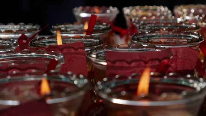 庆祝农历新年期间，道观教堂燃烧的油烛灯产生的火焰。仁慈女神神庙。4k