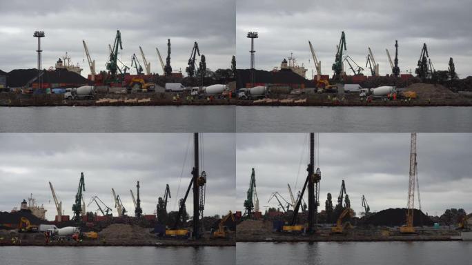 波兰格但斯克-2019年9月: 港口起重机背景下的港口路堤建设。港口堤防施工背景下的门式起重机