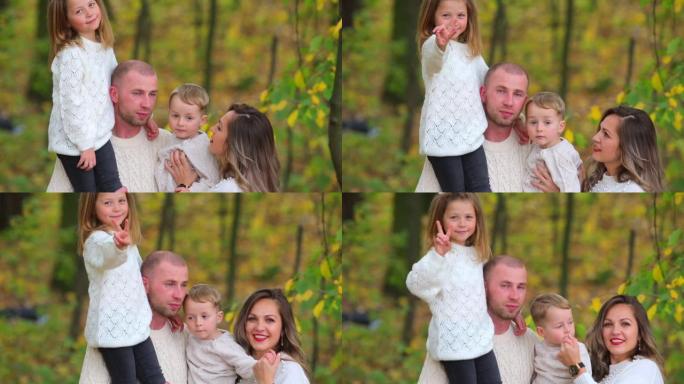 一家人，四个人，在秋天的森林里。