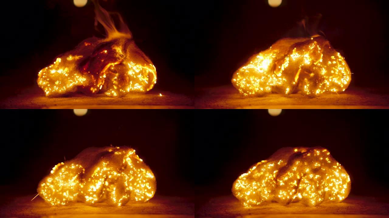 大火的特写镜头通过钢丝绒燃烧并导致其散开