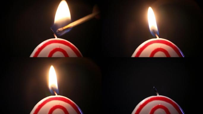 一场特写火柴以数字零的形式点燃节日蜡烛，火焰周围有美丽的倒影。然后火焰熄灭。