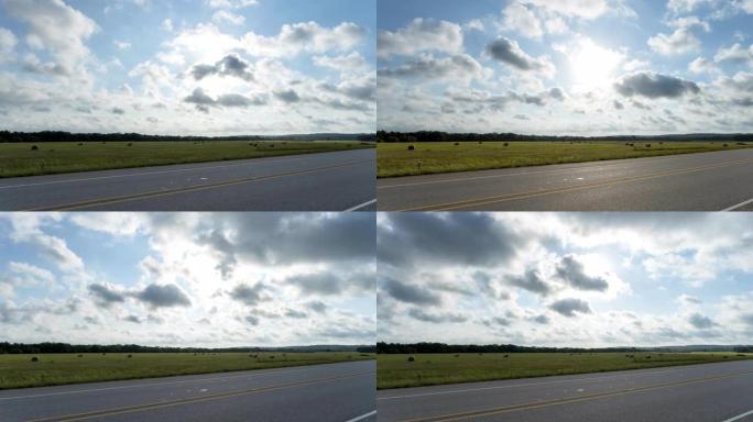 云层经过德克萨斯州广阔的农田，高速公路处于前景