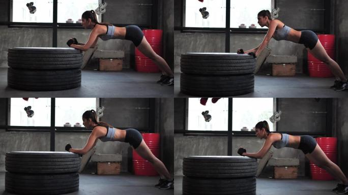 亚洲年轻运动型女性在健身房进行腹肌锻炼，进行交替的身体提升和铺板锻炼。
