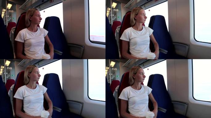 年轻女子坐在火车上看着窗外