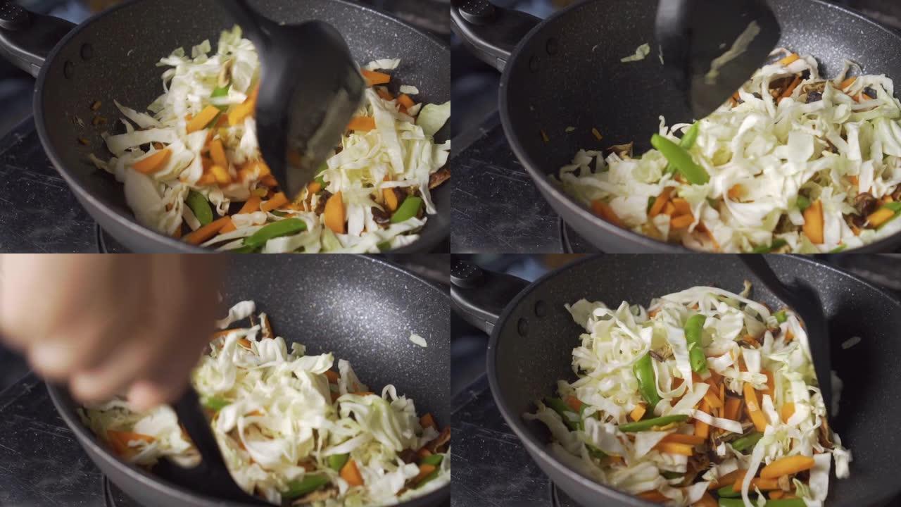 女士在平底锅上煎蔬菜。中国菜。素食节。