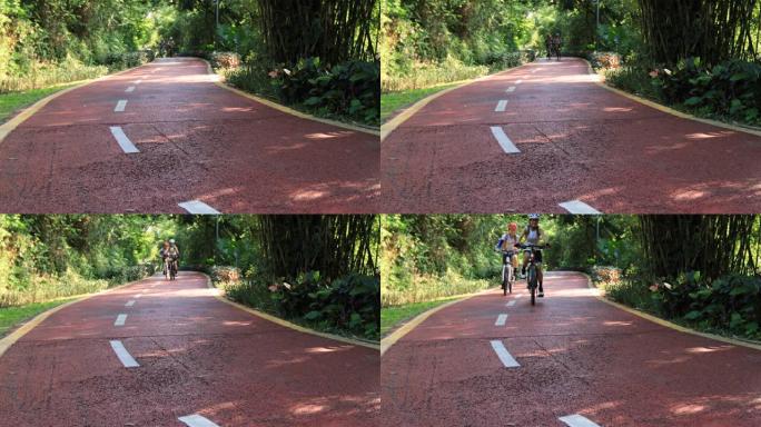 两个女性朋友在公园自行车道上骑行