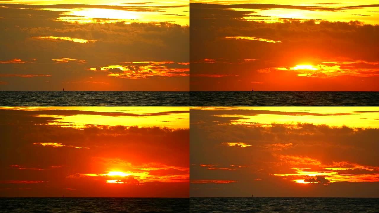 日落橙红色的天空和红色的云在海上移动