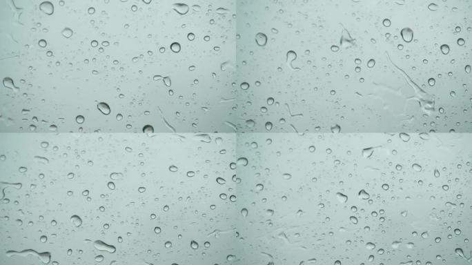 外面的窗户玻璃上的雨。特写。慢动作。玻璃上的雨。雨水在车窗背景上滴水。秋天天气不好。