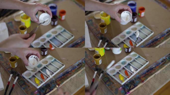 艺术家在调色板上使用油画。艺术概念
