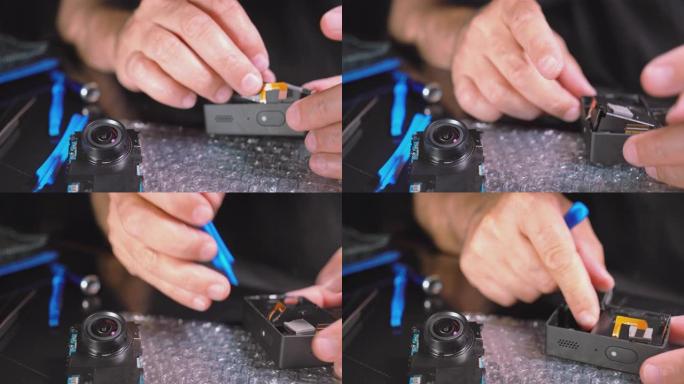 小型电子维修。组装拆卸的行动摄像机的人的手的特写视频。