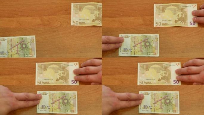 两只手移动保加利亚的钱和欧元