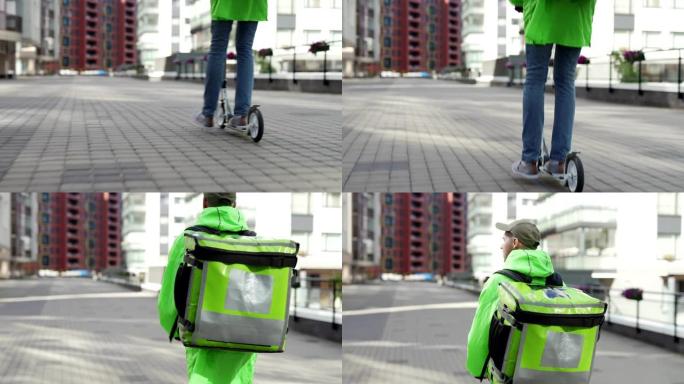 后视图跟随绿色制服的年轻食品快递员在城市街道上骑着踏板车，背着隔热背包，向上倾斜