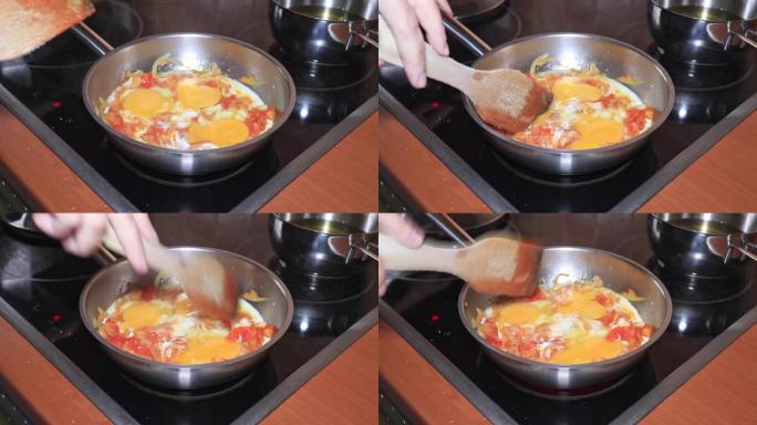 厨师在锅中煮煎蛋卷，在锅中切碎的西红柿和洋葱，在家里用蔬菜煮煎蛋卷
