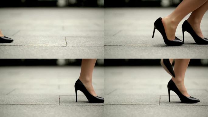 穿着高跟鞋的年轻女商人的脚进城。下班后，女商人穿着高跟鞋在办公室附近行走。慢动作