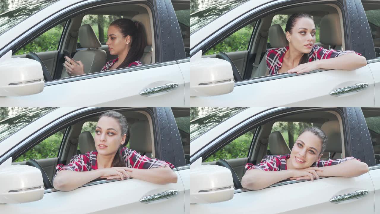 迷人的年轻女子坐在乡村路上的一辆车里对着镜头微笑