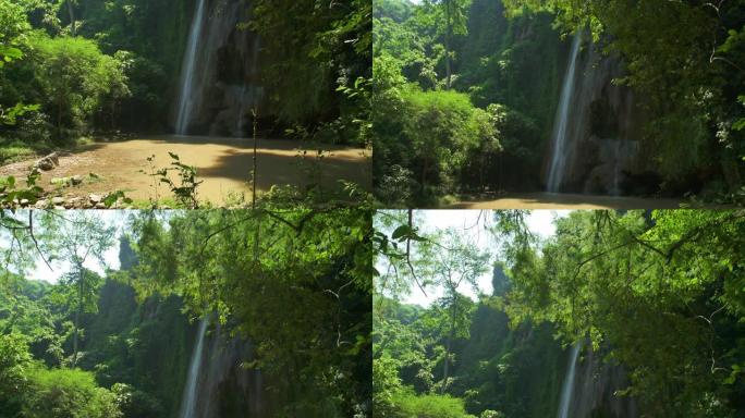 在深林茂密的绿叶和阳光中，令人惊叹的看不见的瀑布景色。萨拉武里亚洲泰国
