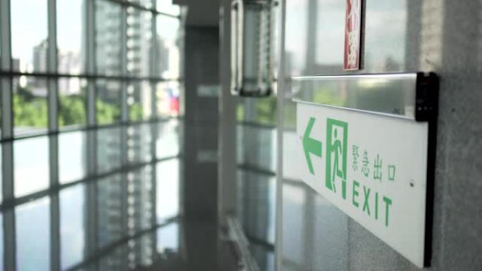 紧急出口，逃生路线标志。公共场所现代建筑中的位置。汉字 “緊急出口” 表示紧急出口。