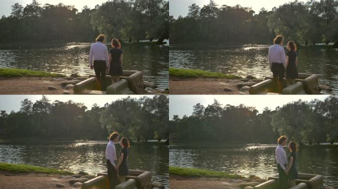 恋爱中的年轻夫妇将硬币扔进公园的水井，然后转身亲吻