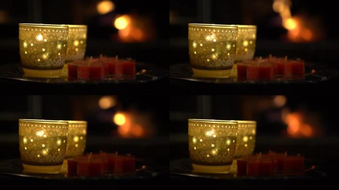 4k圣诞装饰蜡烛和背景壁炉与咆哮的火