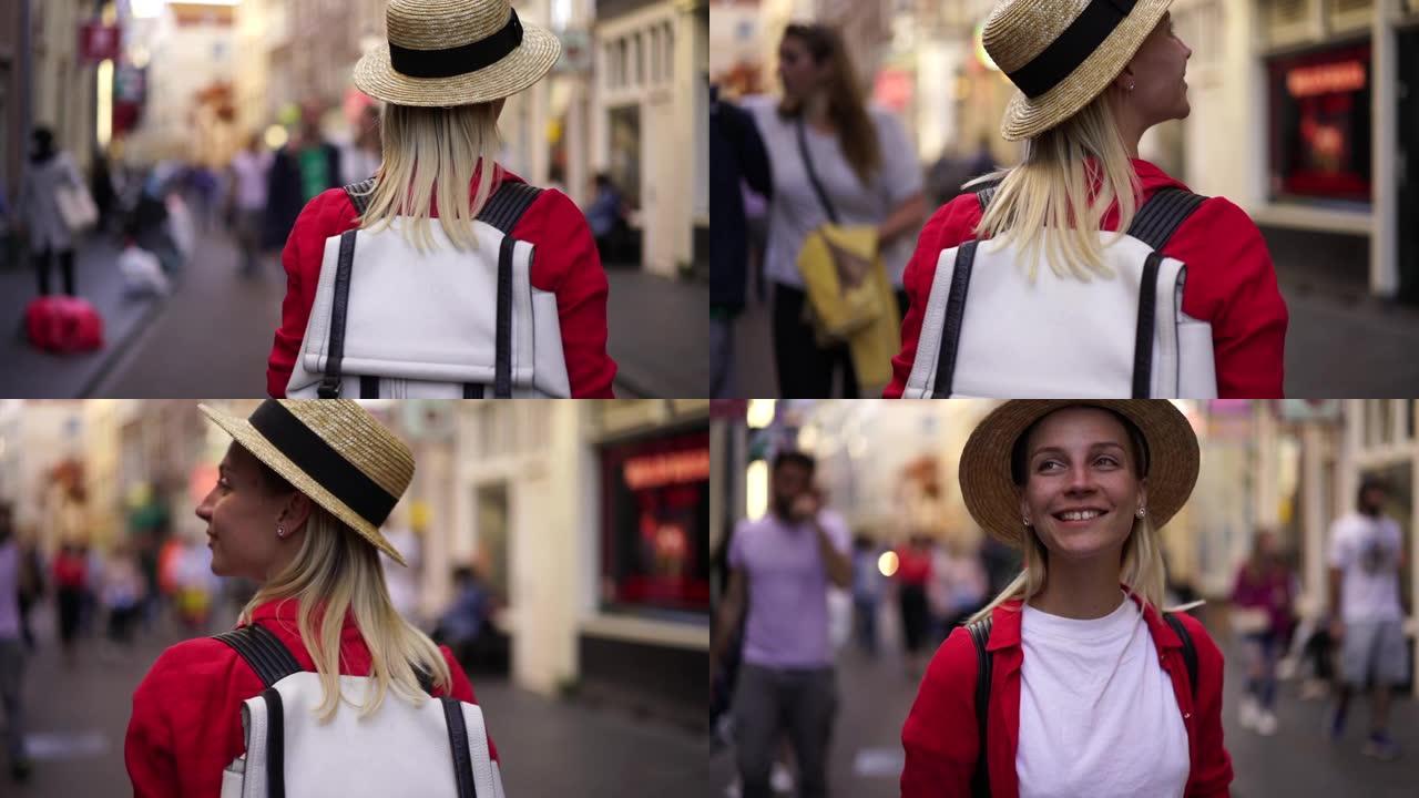 戴着帽子的快乐印象深刻的时髦女孩旅行者在城市漫步，享受当地的氛围