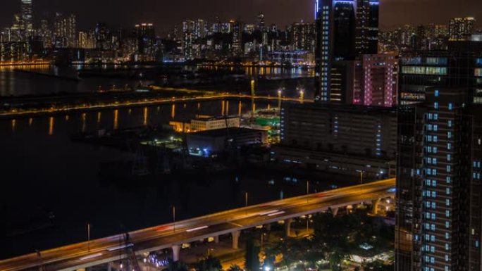 延时俯视图香港城市景观之夜，海港附近城市的天际线