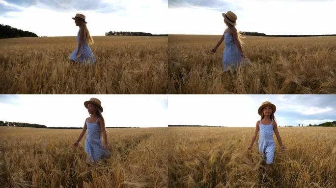 美丽的小女孩，长长的金发走过麦田。戴着草帽的可爱的孩子抚摸着庄稼的金色耳朵。穿着裙子的小孩在大麦的草