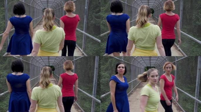 三个女人走开，转身看着桥上的相机