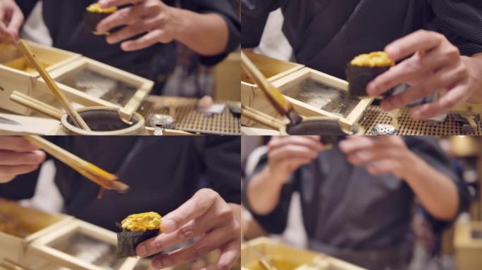 一名厨师用筷子烹饪，并在日本omagase餐厅放入shoyu酱海胆日本料理。