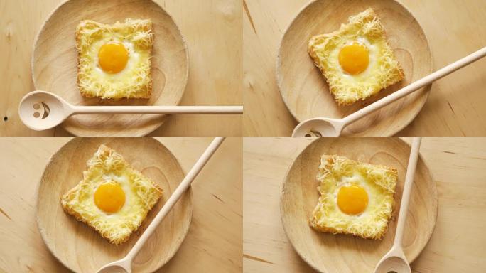 木制厨房桌子上烤面包配煎蛋和奶酪的俯视图
