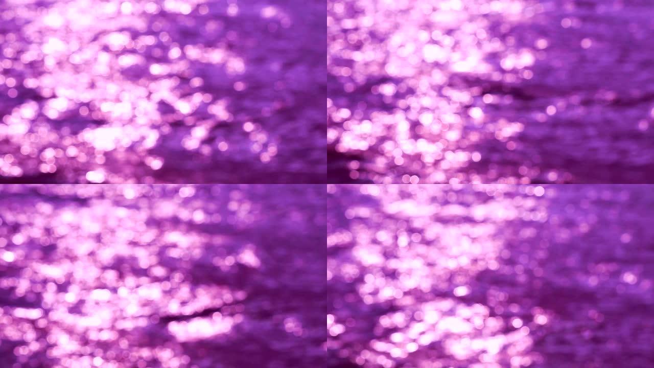 下午紫色和白色bokeh眨眼背景下海面波浪的模糊反射