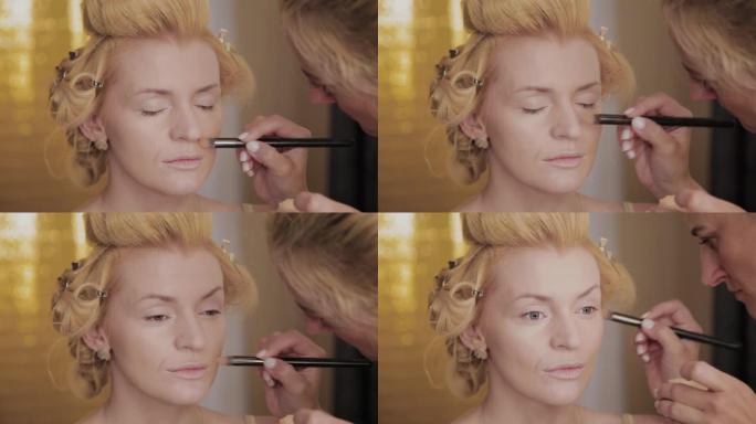 专业化妆师将模特的化妆照片应用于女性