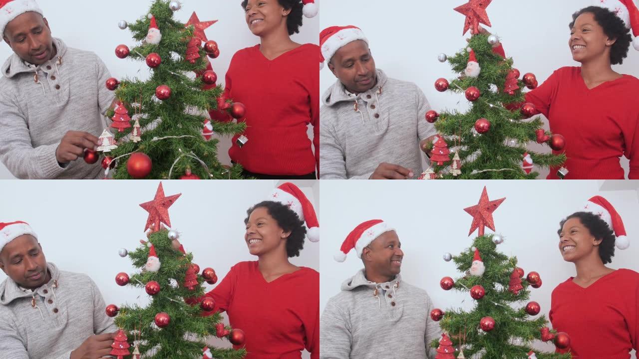 美丽的黑人妇女和男子在家里装饰圣诞树