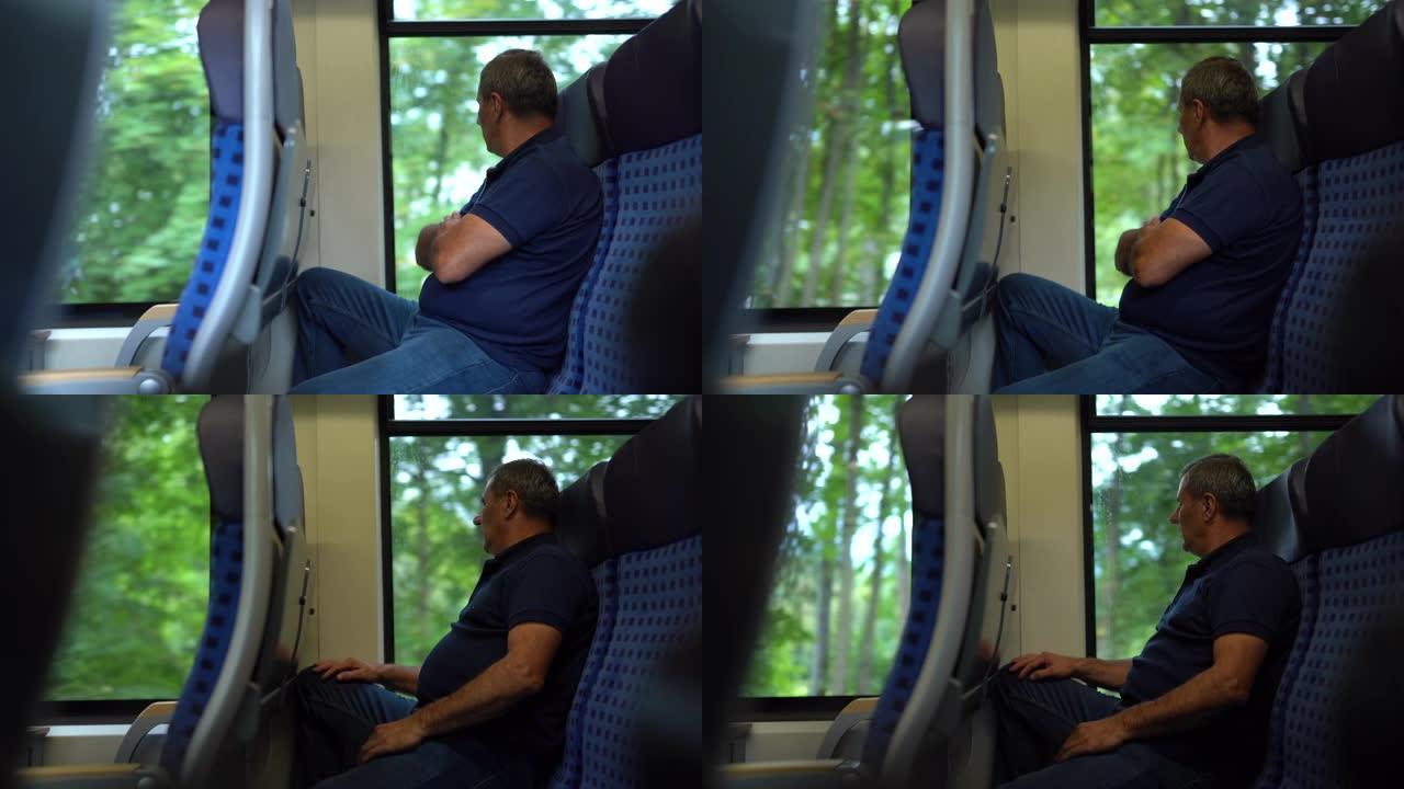 成熟的男人坐火车旅行，看着风景