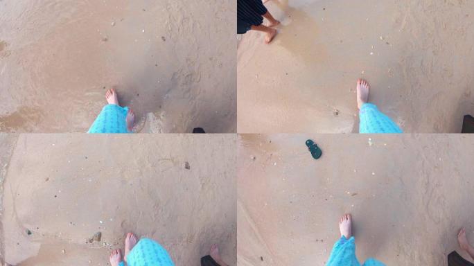 一个女孩的腿是谁走在沙滩上。击落。观点