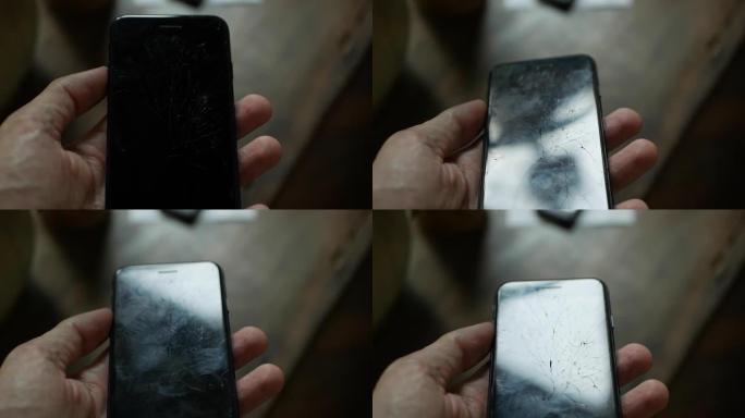 屏幕破碎的智能手机概念。手持显示器破裂的手机的人的俯视图。破裂，破碎的液晶显示器触摸。现代手机上的屏