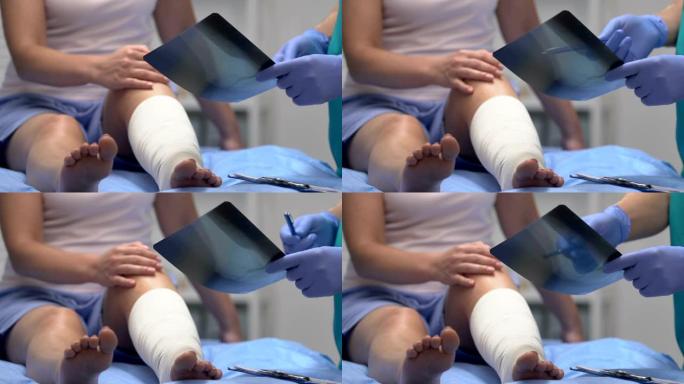 创伤专家向腿部创伤，医疗保健患者解释x射线结果