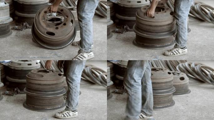 亚洲工人在用重型气枪拧紧车轮螺母时，用热钢号冲压轮胎，用手工组装轮胎。4k慢动作。