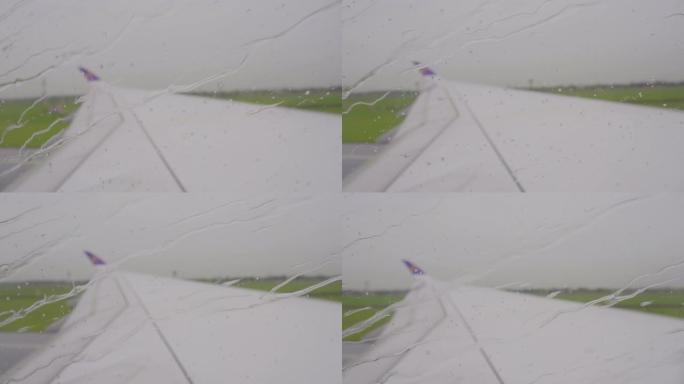 在雨季，近距离拍摄飞机窗户座位外的雨滴。