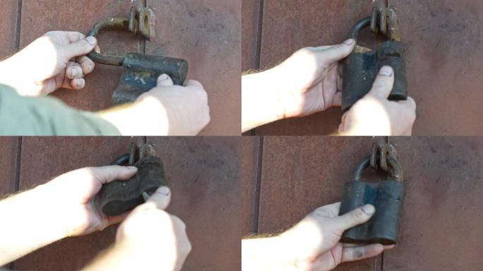 男人的手将谷仓的门关上旧挂锁。