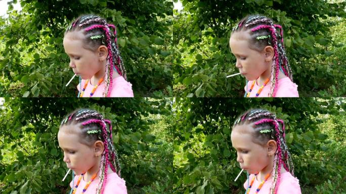在乡村花园里留辫子的小女孩的肖像
