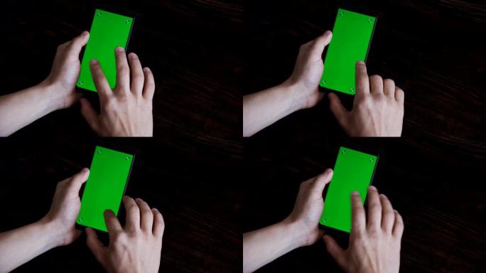 绿屏手机的特写镜头。智能手机屏幕上的色度键。一个人在手机屏幕上滚动信息。点击并滑动。准备绿屏插入信息