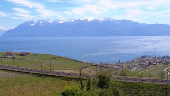 日内瓦湖附近有葡萄园和瑞士阿尔卑斯山的铁路景观。瑞士