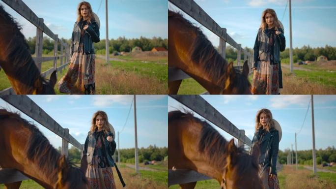 时尚女性在放牧马附近摆姿势