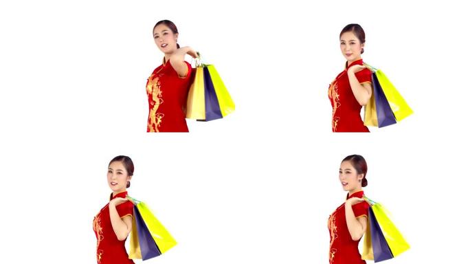 年轻漂亮的中国女人手里拿着购物袋