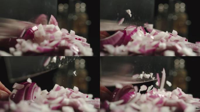 慢动作: 煮在黑色桌子上切新鲜的红洋葱头