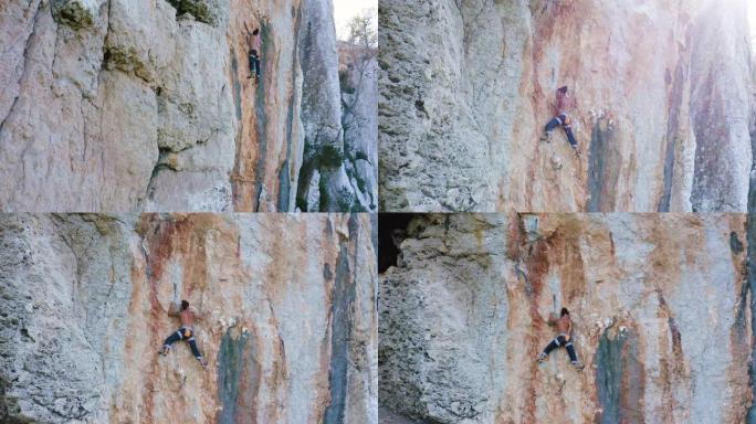 一个年轻的登山者登上垂直的岩石。4K