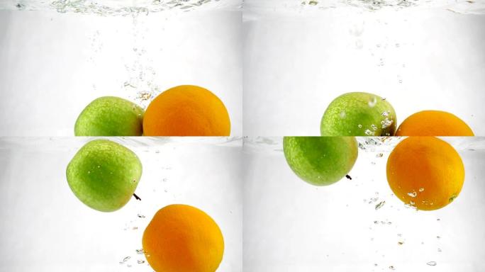 橙色和青苹果在水中以慢动作旋转的气泡旋转。